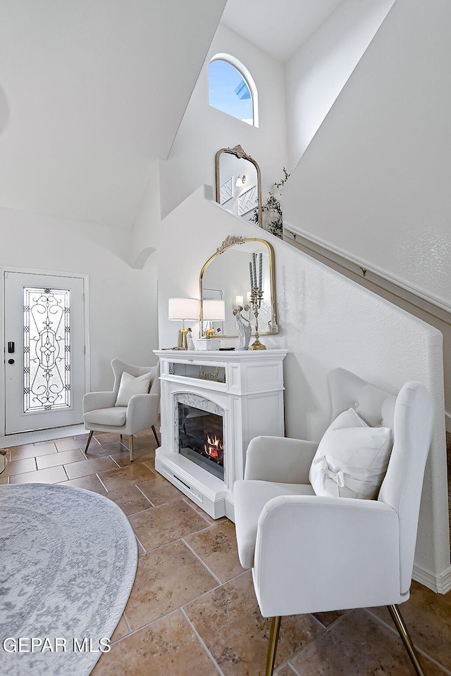 living area featuring high vaulted ceiling