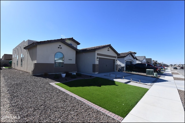 exterior space with a garage, a yard, and a swimming pool