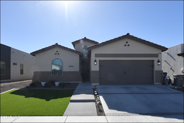 view of front of home featuring a garage and a front lawn