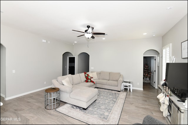 living room featuring light hardwood / wood-style floors and ceiling fan