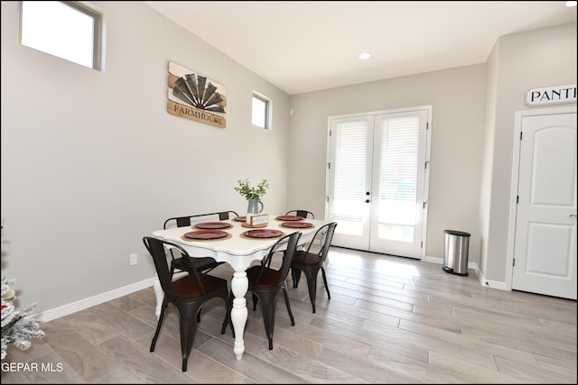 dining space featuring french doors and light hardwood / wood-style floors