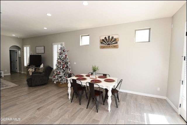 dining area with a healthy amount of sunlight and light hardwood / wood-style flooring