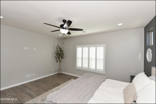 bedroom with ceiling fan and dark wood-type flooring