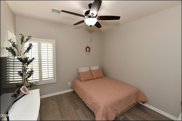 bedroom featuring dark hardwood / wood-style flooring and ceiling fan