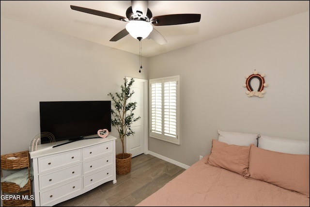 bedroom with dark hardwood / wood-style floors and ceiling fan