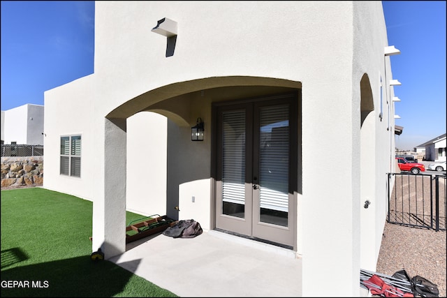 property entrance with a patio and french doors