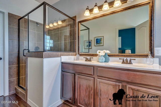 bathroom with hardwood / wood-style floors, vanity, and an enclosed shower