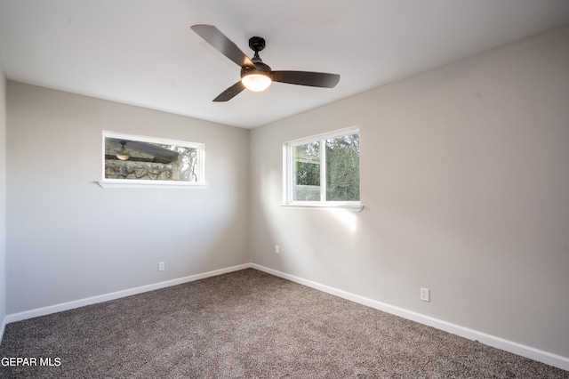 carpeted spare room with ceiling fan