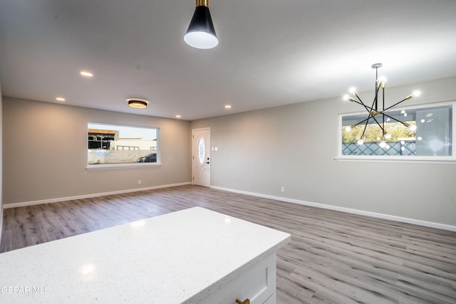 interior space with hardwood / wood-style flooring and a chandelier