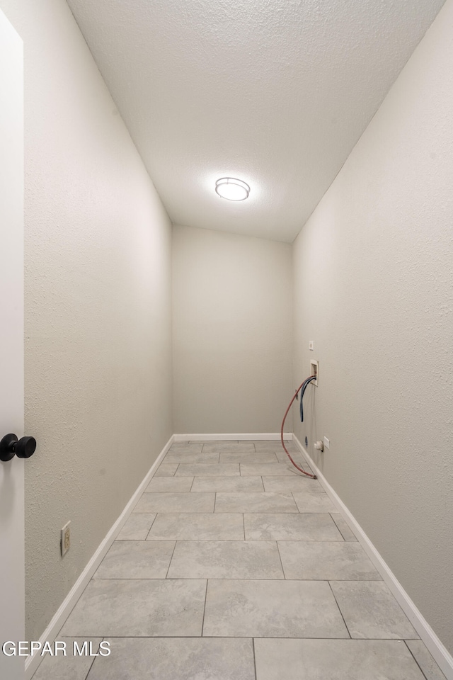 washroom with washer hookup, hookup for a gas dryer, and a textured ceiling