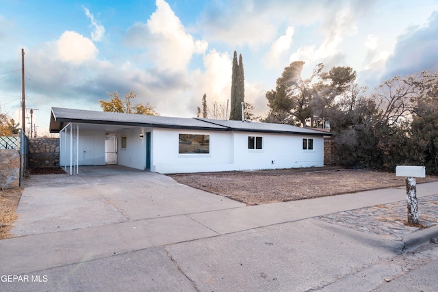 ranch-style home featuring a carport