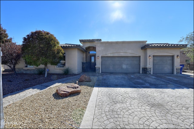 mediterranean / spanish-style house with a garage