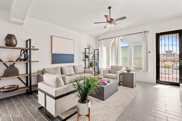 living room with hardwood / wood-style floors, a wealth of natural light, ceiling fan, and vaulted ceiling