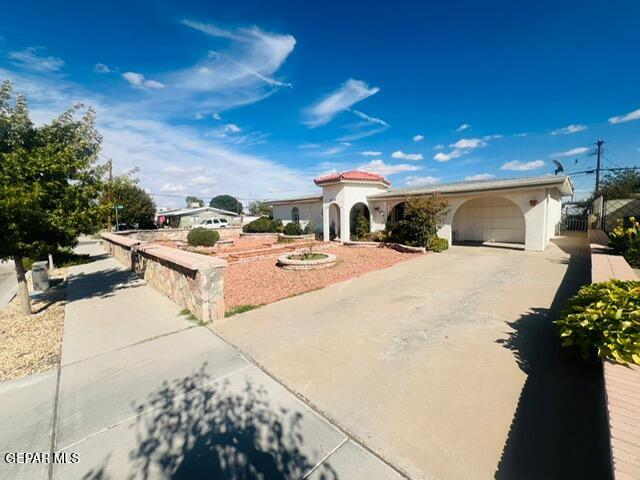 mediterranean / spanish home featuring a garage