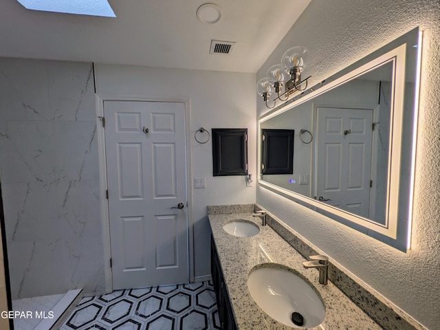 bathroom featuring vanity and a skylight