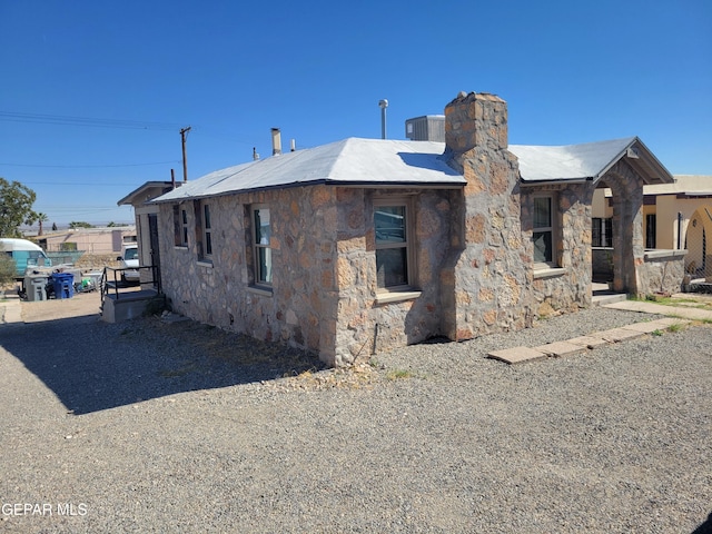 view of side of home featuring central AC unit