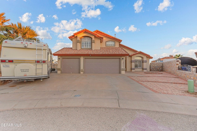 12196 Dos Rios Dr, El Paso, TX 79936 - mediterranean / spanish-style home featuring a garage