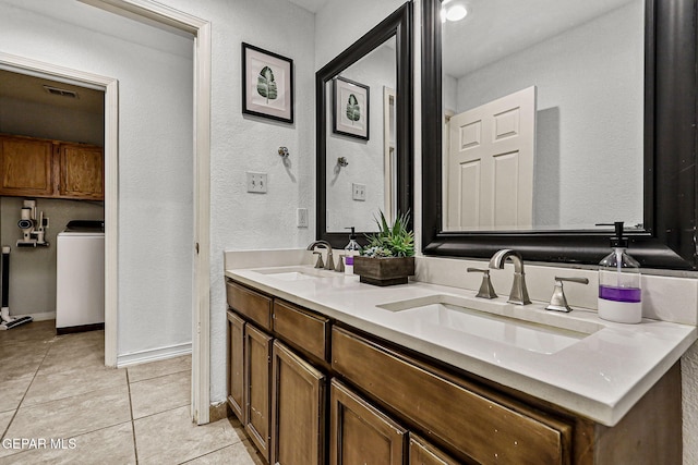 12196 Dos Rios Dr, El Paso, TX 79936 - bathroom featuring vanity, tile patterned flooring, and washer / clothes dryer