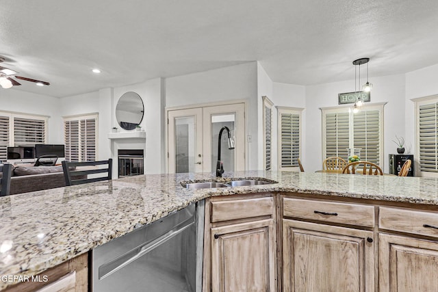 12196 Dos Rios Dr, El Paso, TX 79936 - kitchen with pendant lighting, sink, ceiling fan, and a textured ceiling