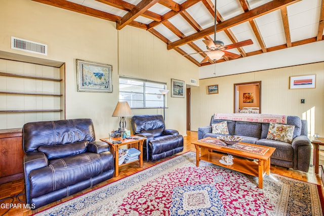 living room with ceiling fan, beamed ceiling, high vaulted ceiling, and wood-type flooring