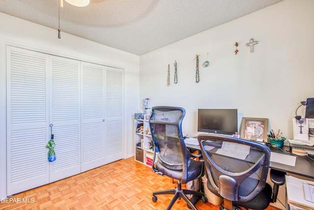 office with a textured ceiling and light parquet floors