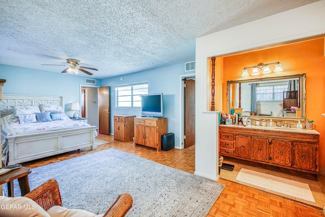 bedroom featuring light parquet floors, a textured ceiling, and ceiling fan