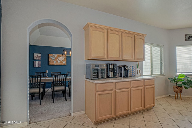 kitchen with light brown cabinets and light tile patterned floors