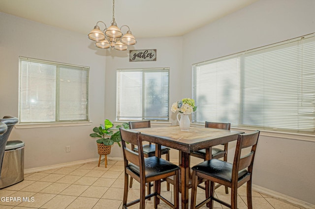 tiled dining room featuring a chandelier