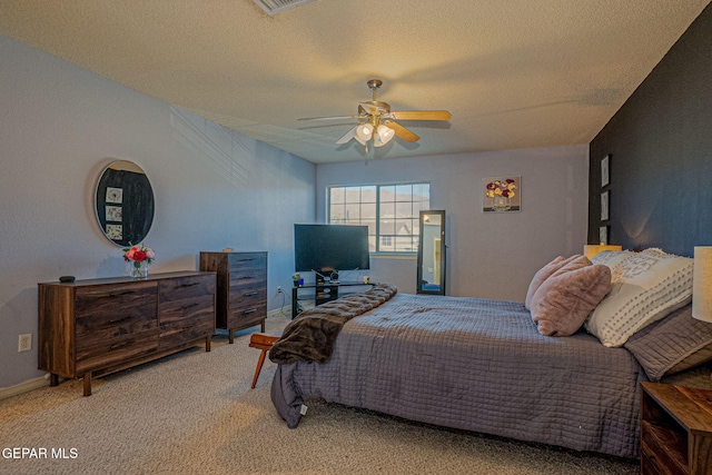 carpeted bedroom featuring a textured ceiling and ceiling fan