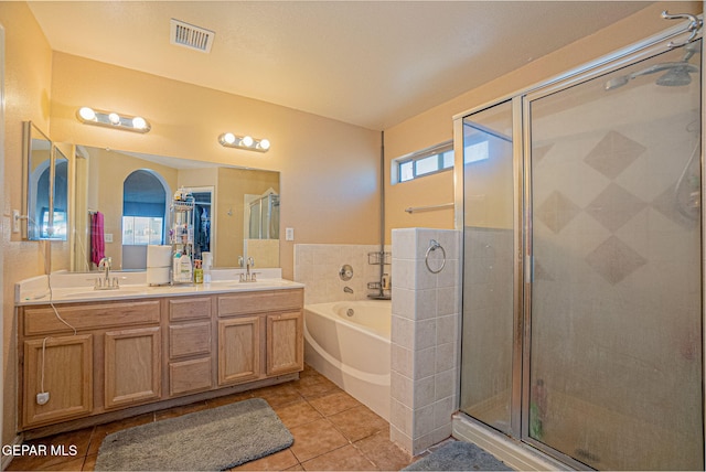 bathroom with shower with separate bathtub, vanity, and tile patterned flooring