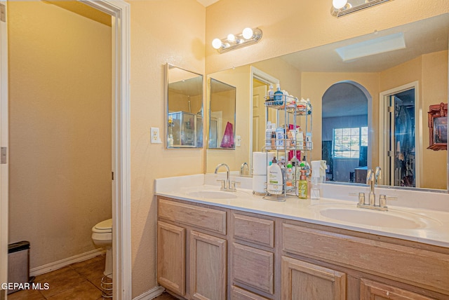 bathroom featuring vanity, tile patterned floors, and toilet