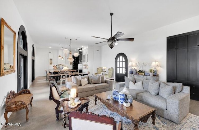 living room featuring light carpet and ceiling fan