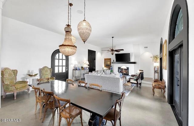 dining room featuring ceiling fan with notable chandelier