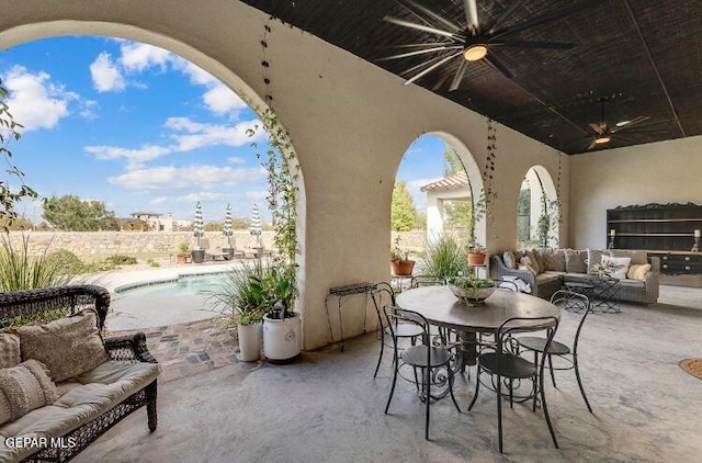 view of patio featuring ceiling fan, a fenced in pool, and an outdoor hangout area