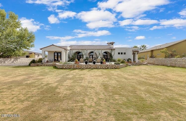 rear view of property featuring a yard