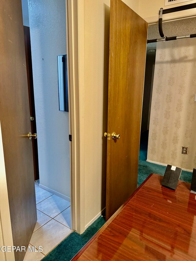 hallway with tile patterned flooring