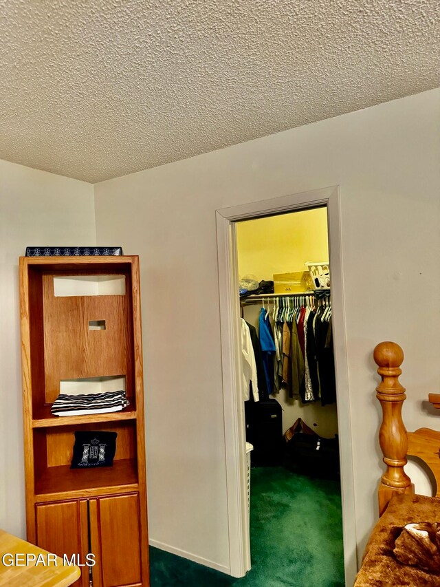 carpeted bedroom with a textured ceiling and a closet