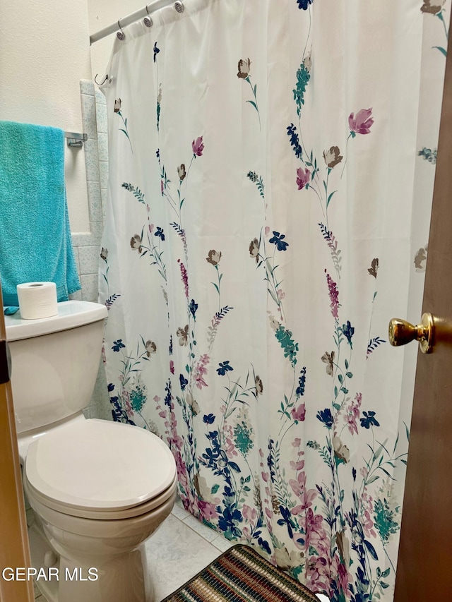 bathroom with toilet and tile patterned floors
