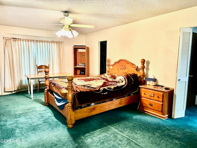 carpeted bedroom with ceiling fan and a textured ceiling