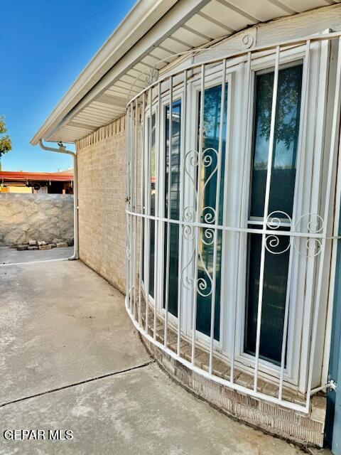 10521 Gaius Dr, El Paso, TX 79924 - view of exterior entry featuring brick siding and a patio