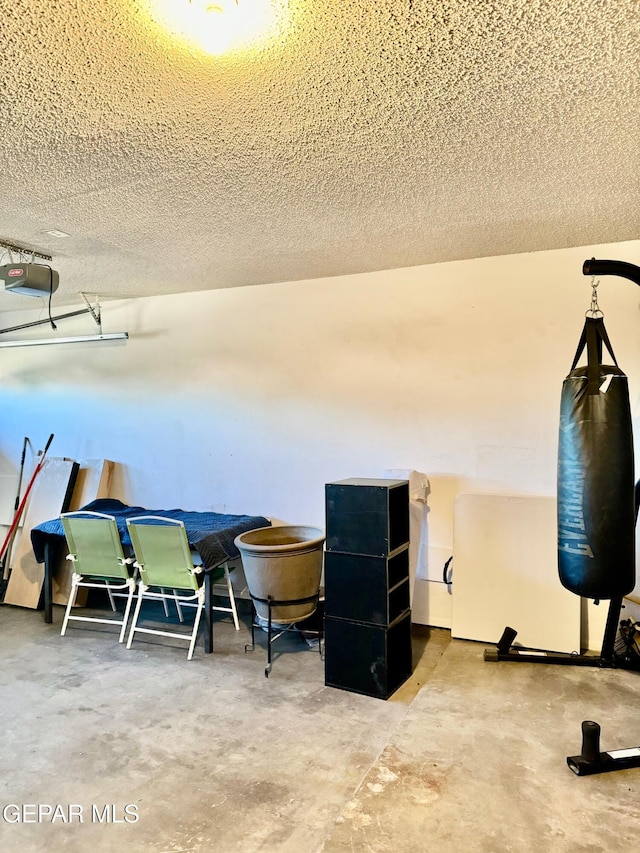 interior space featuring concrete flooring and a textured ceiling