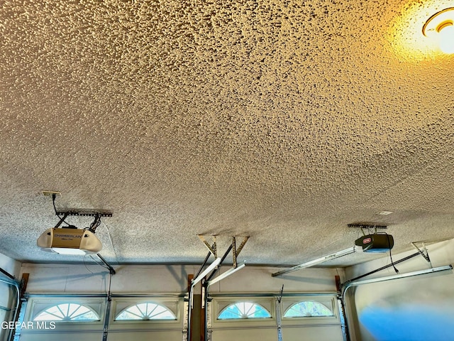 interior details featuring a garage door opener and a textured ceiling