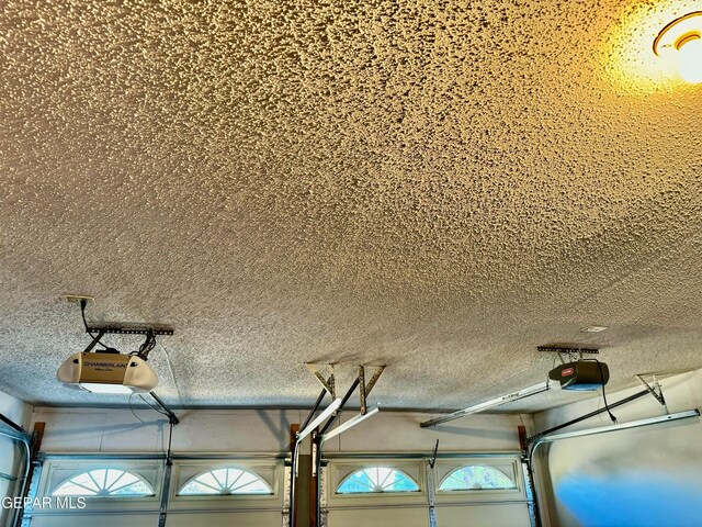 10521 Gaius Dr, El Paso, TX 79924 - garage view of a textured ceiling and a garage door opener