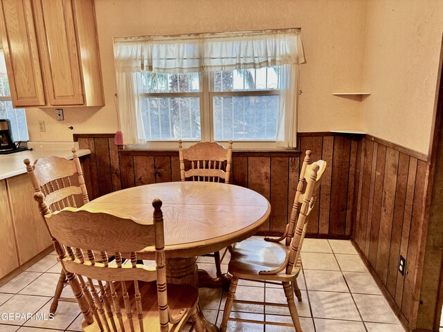 10521 Gaius Dr, El Paso, TX 79924 - dining space featuring plenty of natural light, light tile patterned floors, wooden walls, and a wainscoted wall