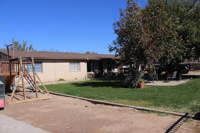 exterior space featuring a front lawn and a playground