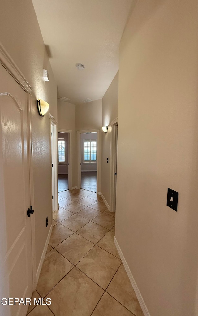 hall with light tile patterned flooring