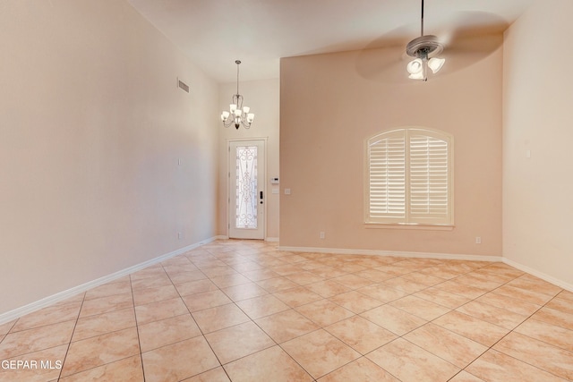 tiled entrance foyer with a high ceiling and ceiling fan with notable chandelier