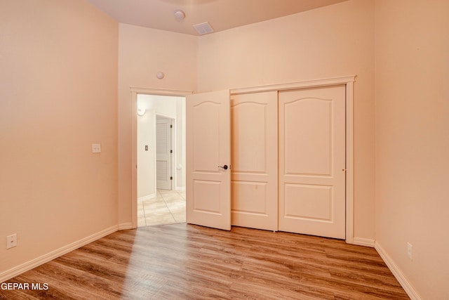 unfurnished bedroom featuring a closet and light hardwood / wood-style flooring