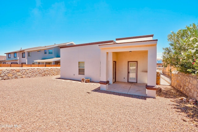 rear view of property featuring a patio