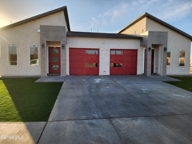 contemporary house with a garage and a front yard